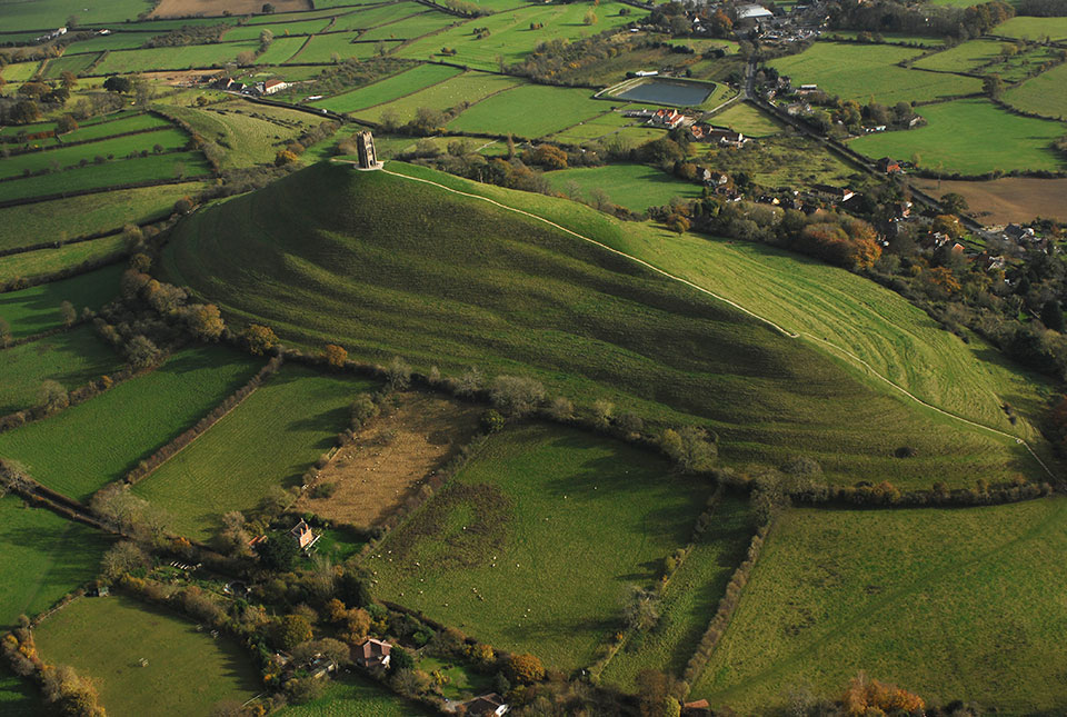 Glastonbury Tor rises above the low-lying wetlands of the Somerset Levels, one of the sample areas for the new research. BGS © UKRI.