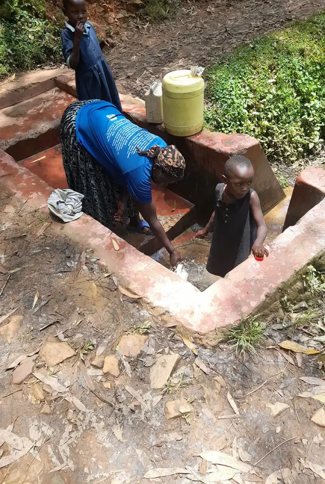 Gold mining activities (milled ore washing and sluicing) and community drinking water downslope of ASGM activities. © Maureene Auma Ondayo. 