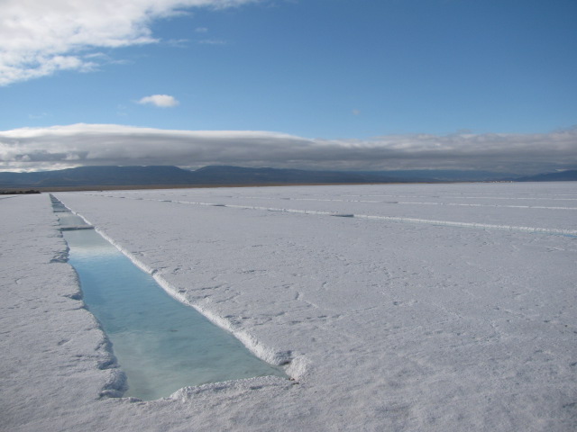 A flat expanse of white salt with a rectangular trench cut in