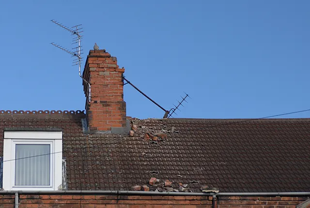 a broken chimney stack and TV aerial